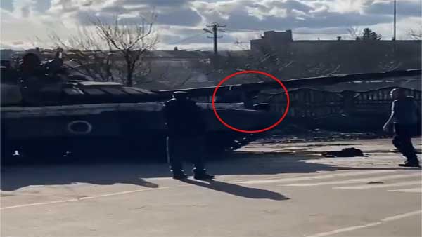 Watch: Ukrainians climb on top of Russian tank to slow its advance