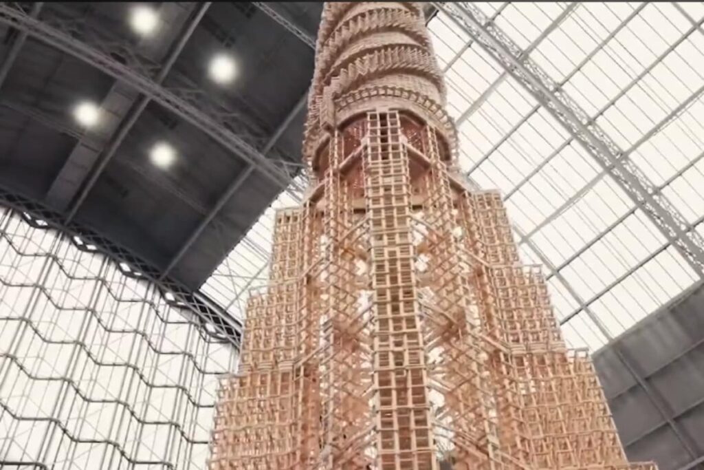 Artists Build World's Tallest Wooden Toy Block Tower Only To Crash It In Domino Effect