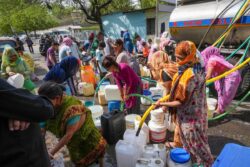 Delhi Water Crisis: Residents Chase Water Tankers with Buckets | Video