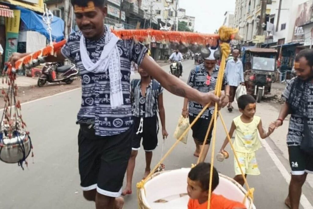 In Bengal, Lord Shiva Devotee Carries Water On One Shoulder And Daughter On Another