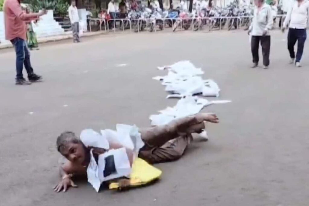 MP Man Rolls To Collector's Office With Documents Around His Neck To Protest Corruption | Watch